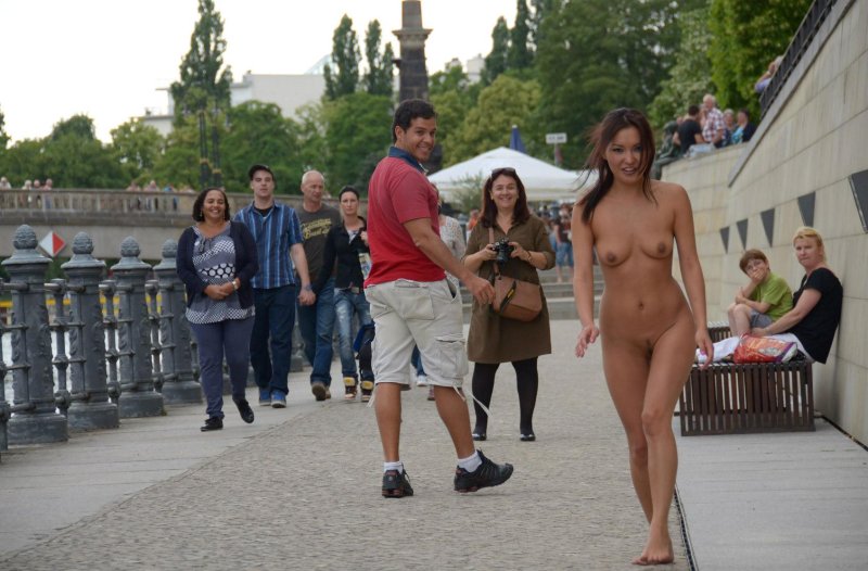 The girl undresses in public