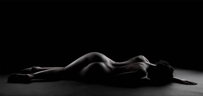 Naked woman on a black background