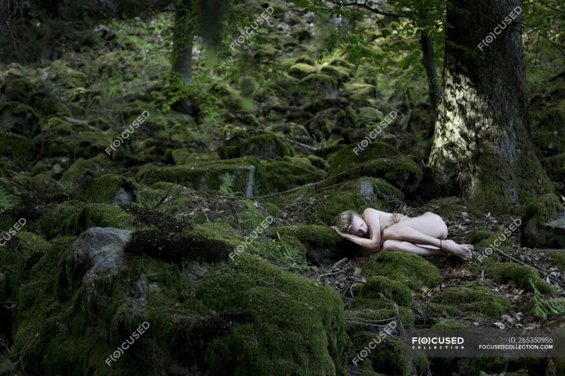 Woman sleeps naked in the forest