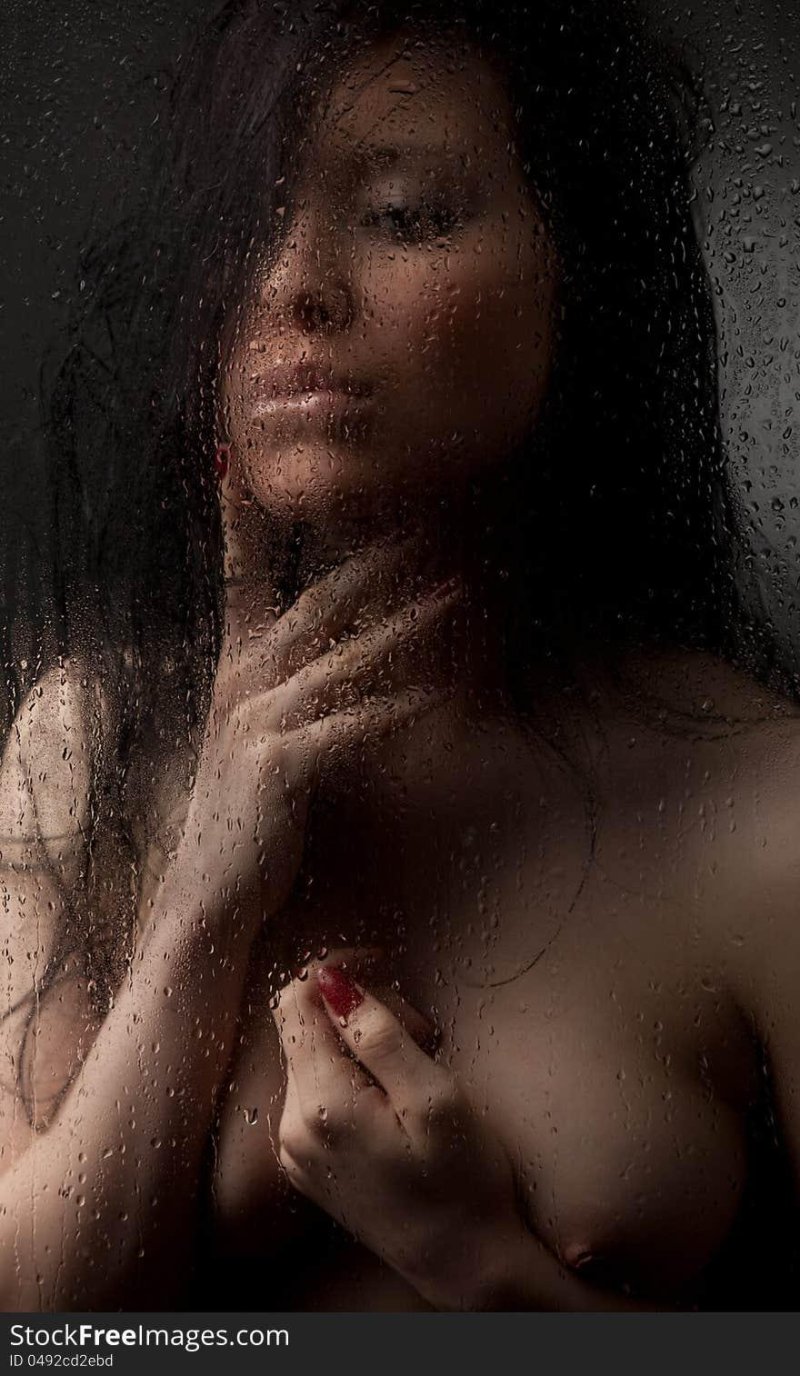 Girl behind wet glass